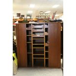 Mid 20th century Teak Office Stationery Cupboard, the two slide back tambour doors opening to reveal