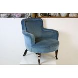 Late 19th century Blue Upholstered Low Armchair raised on square tapering front legs with castors,