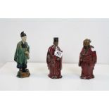 A three chinese pottery figures in costume.