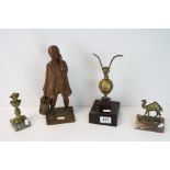 A carved wooden figure of a boy carrying bucket, a spelter figure of eagle standing on sphere, a