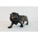 a brass bronze figure of a lion.