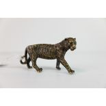 A brass/bronze figure of a tiger.