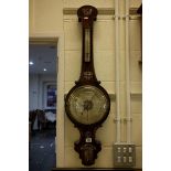 An antique Rosewood banjo barometer with mother of pearl inlaid decoration.
