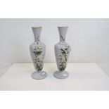 A pair of lilac ground glass vases decorated with birds..