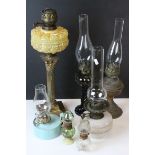 Collection of Oil Lamps including one with a Brass Corinthian Column Support and Moulded Yellow