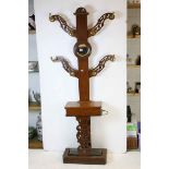 Victorian Oak Hall Stand, the four pierced carved arms with brass hooks, central circular mirror,