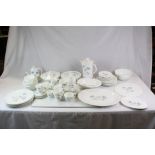 A comprehensive Wedgwood Ice Rose pattern dinner service cups saucers meat plates veg dishes