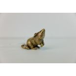 A brass figure of a rat or mouse.