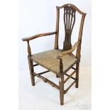 George III Style Oak Elbow Chair with pierced splat and rush seat, 104cms high