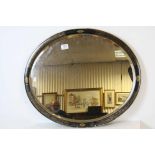 Early 20th century Oval Bevelled Edge Mirror contained in a Black Lacquered Frame with gilt