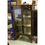 Art Nouveau Mahogany Glazed Display Cabinet with inlaid copper and wood motifs, the two glazed doors