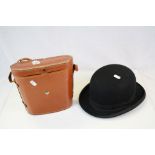 A Christys of London vintage bowler hat and a cased pair of Zenith binoculars.