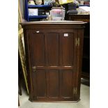 19th century Oak Hanging Corner Cabinet, the single panelled door opening to reveal two shelves,