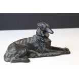 A cast iron recumbent figure of Russian dog.