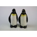 A pair of ceramic penguins with signature to base. Approx 85mm in height.
