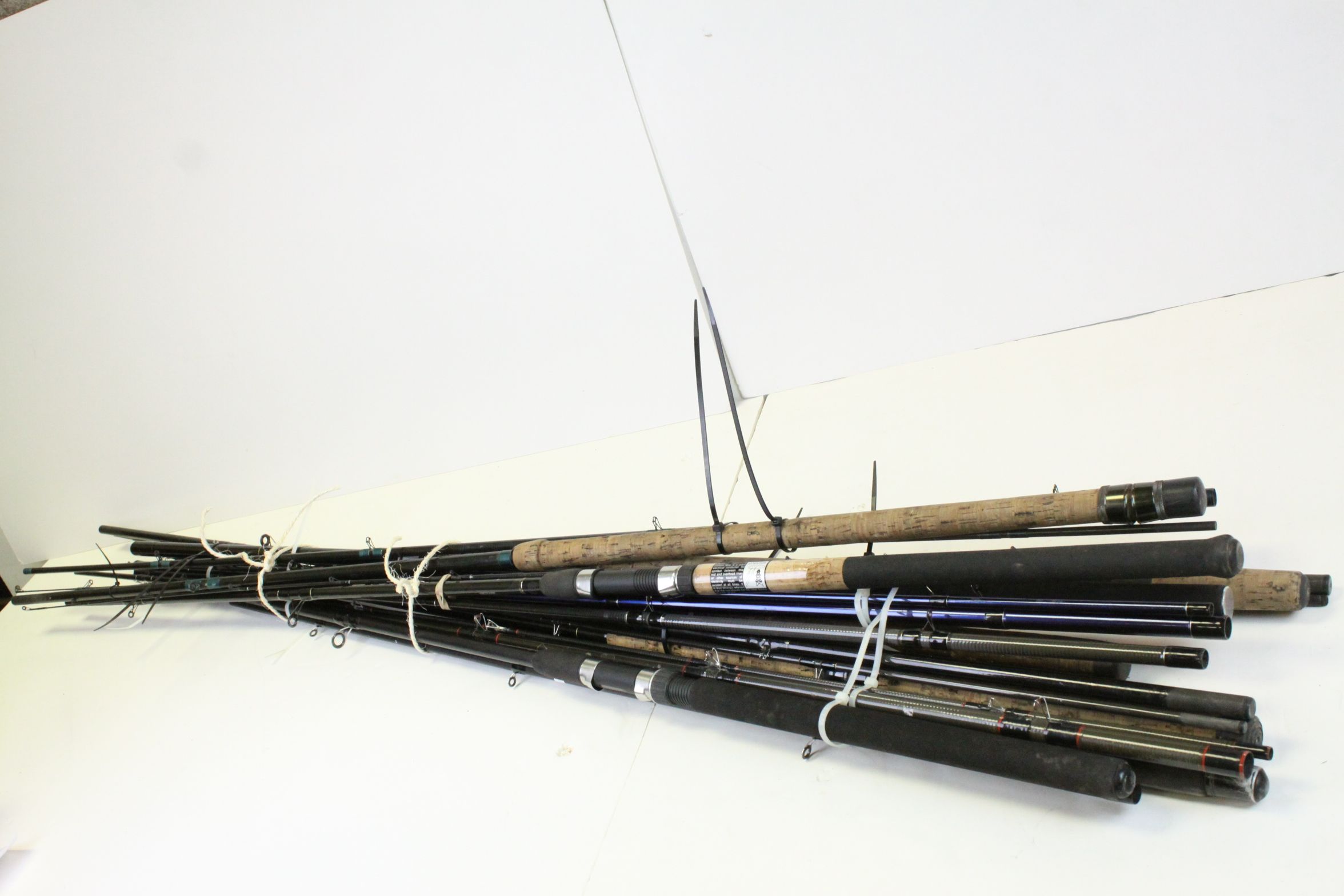 A quantity of coarse fishing rods to include Shakespeare Daiwa etc.