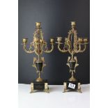 A pair of antique slate and marble and brass candle stick garnitures raised on small brass feet.