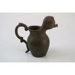 A small bronze miniature drinking vessel.