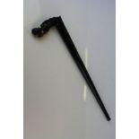 An oriental ebony bladed swagger stick with ornately carved dragon head decoration to the handle.