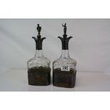 A pair of Victorian glass decanters with fully hallmarked silver mounts, glass etched with grape and