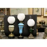 Three Late Victorian Oil Lamps, each with Opaque Glass Globe Shades and Chimneys, the largest with a