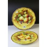 Pair of Coalport Cabinet Plates, hand painted with fruits by Mary Dennis, with gilt rims, 27.5cms