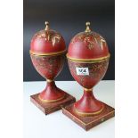 A pair of contemporary metamorphic painted lidded Urns that convert to candle stands.