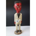 Carved Wooden Figure of a Red Man wearing a suit, 39cms high