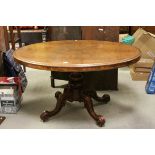 Victorian Walnut Oval Tilt Top Loo / Breakfast Table, raised on a quadruped base with castors,