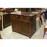 Early 19th century Mahogany Cupboard / Sideboard, the Two Drawers with oval brass handles, over