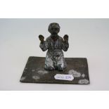A cold painted cast spelter figure knelt on prayer mat, marked Austria to base.