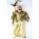 A vintage wooden puppet in the form of a Persian or turkish man in costume