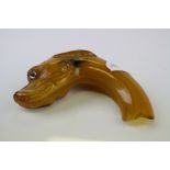 A vintage parasol handle in the form of a dogs head.