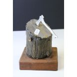 Bronzed and Steel Sculpture of an Axe in a Log, raised on wooden plinth, 13cms high