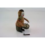 A Vintage Schuco clockwork drumming clown figure complete with key.