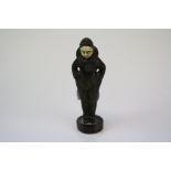 A small bronze figure with carved ivory face.