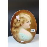 An antique oval porcelain plaque painted with the portrait of a young women signed E J Boys.