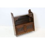 Late Victorian Arts and Crafts Mahogany Hanging Shelf with shaped supports, the two cupboard doors