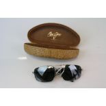 A cased pair of Maui Jim designer sunglasses with original case.