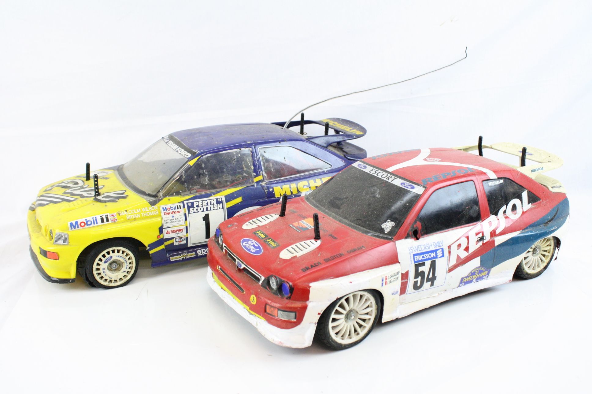 A Tamiya 58125 Ford Escort RS Michelin Pilot with TA01 chassis together with a Tamiya Ford Escort RS