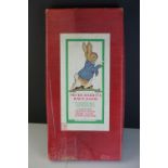 Boxed Frederick Warne & Co Peter Rabbit's Race Game containing four lead figures and two dice,