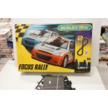 Boxed Scalextric 1095 Focus Rally with two stock cars, appearing complete but unchecked. Plus a
