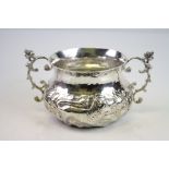 Edwardian Britannia silver twin handled sugar bowl, repousse unicorn, lion and floral decoration