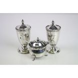 Two Edwardian matched silver pepper pots, plain polished form raised on circular foot, reeded