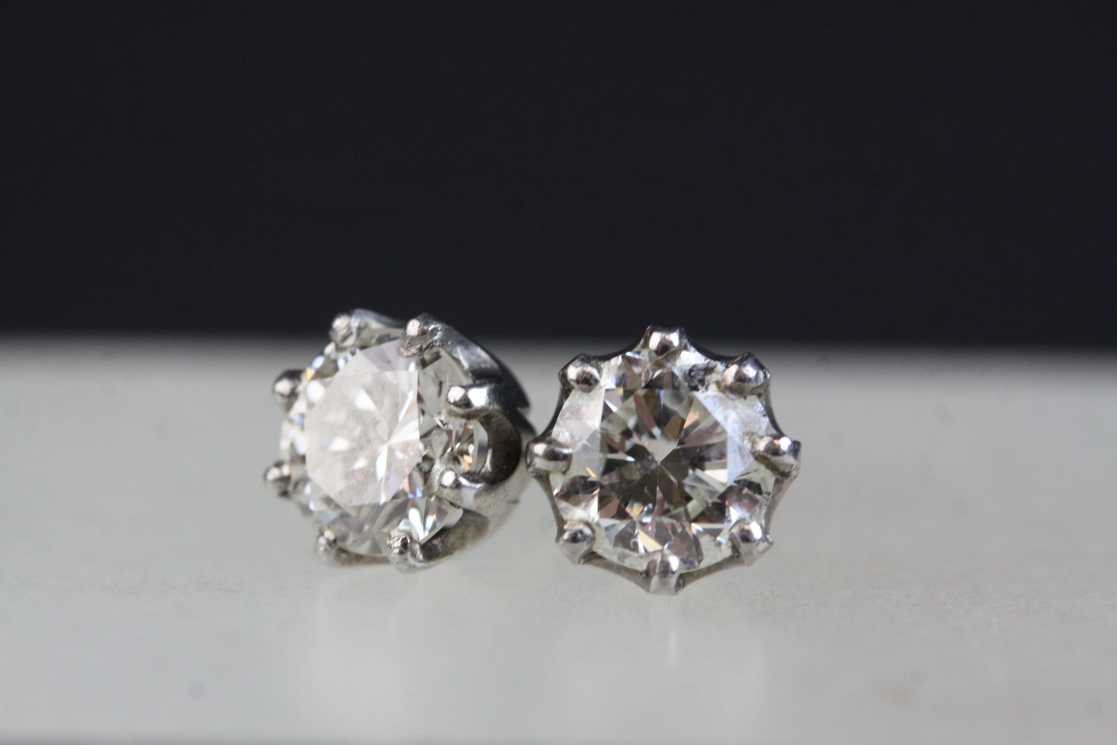 Pair of diamond solitaire stud earrings, each round brilliant cut diamond weighing approx 1.0 carat,