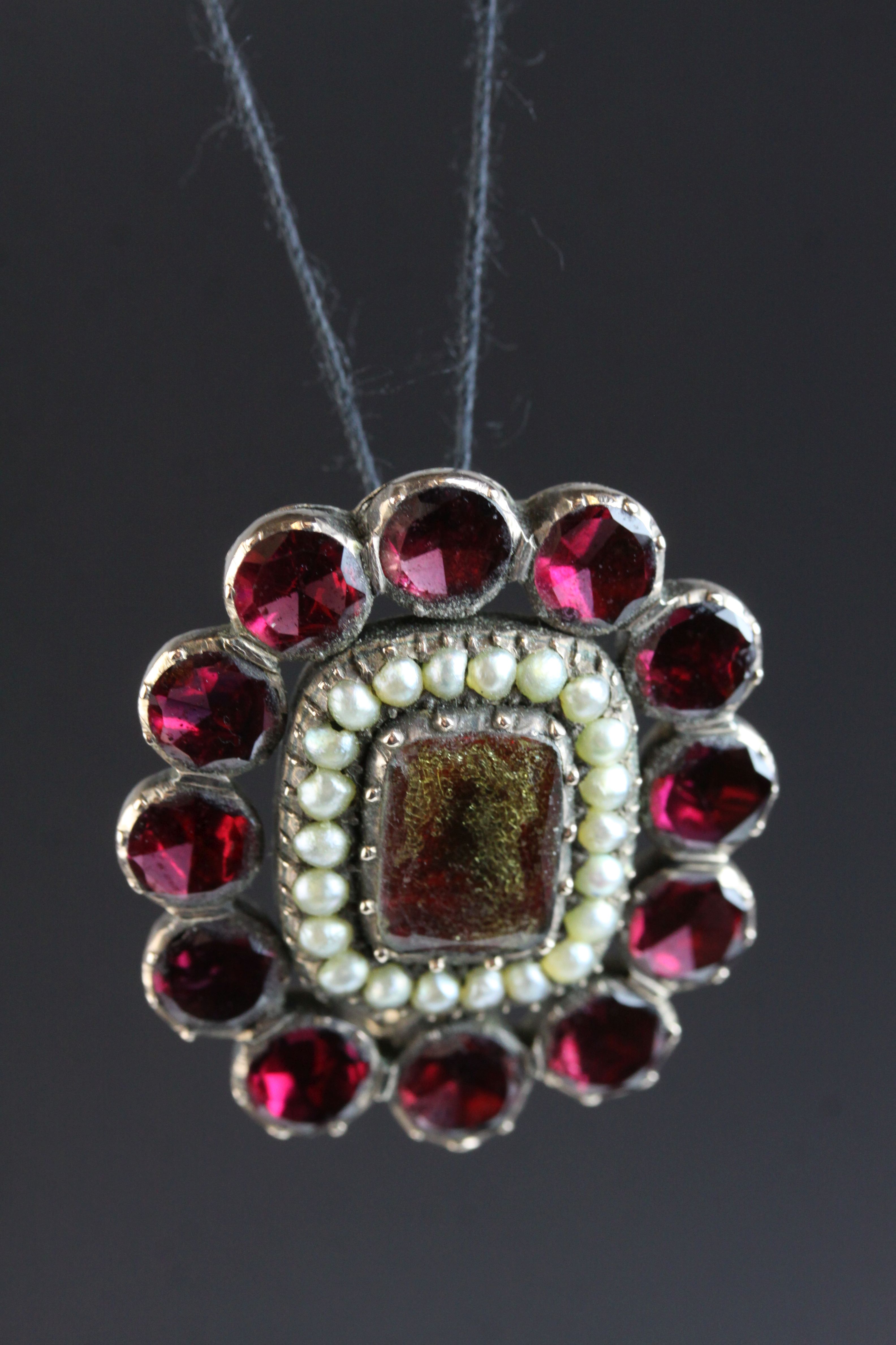 Georgian flat cut garnet and seed pearl brooch, unmarked rose gold, the central flat cut rectangular