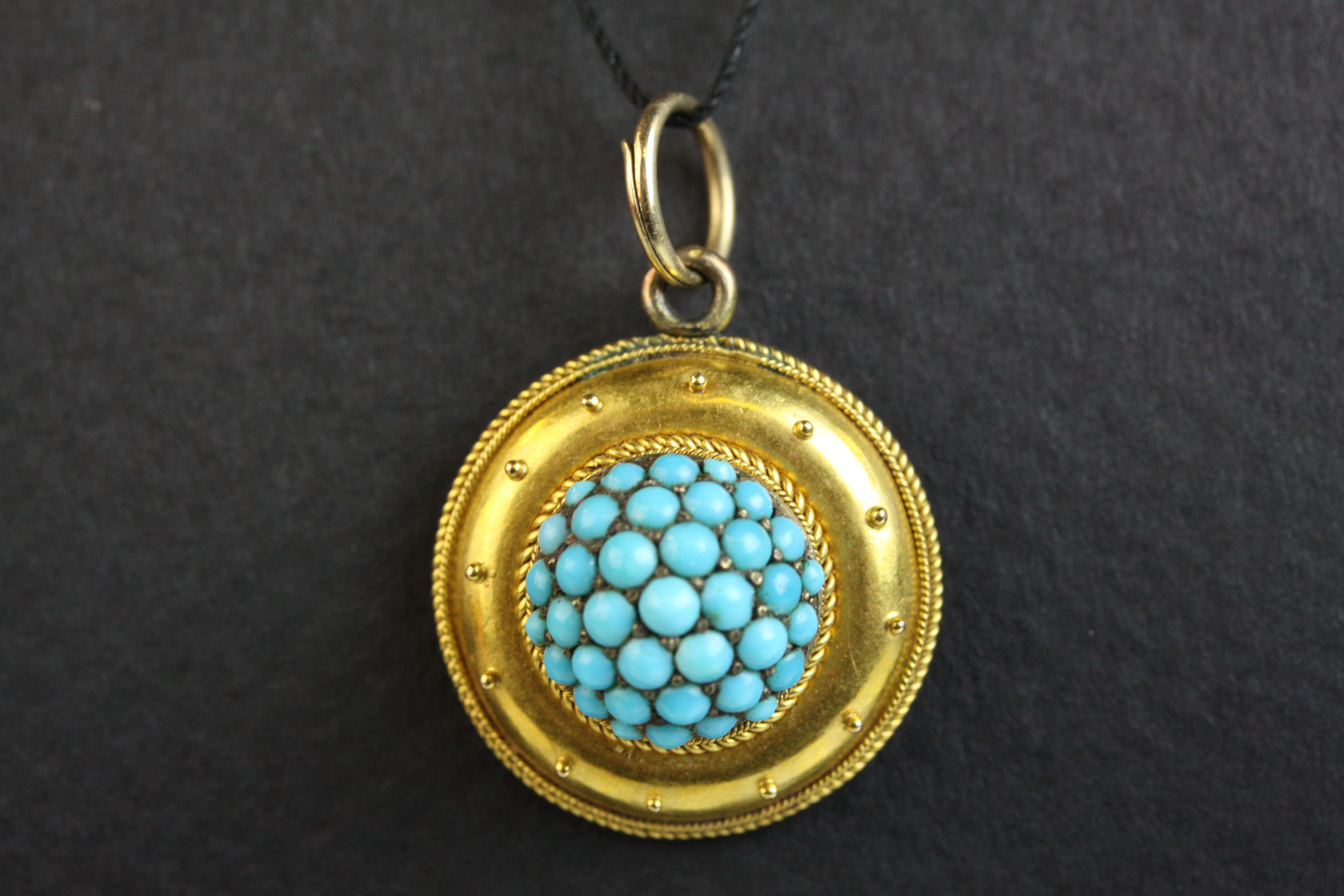 Victorian Etruscan turquoise target pendant, unmarked gold, the centre comprising thrity-seven