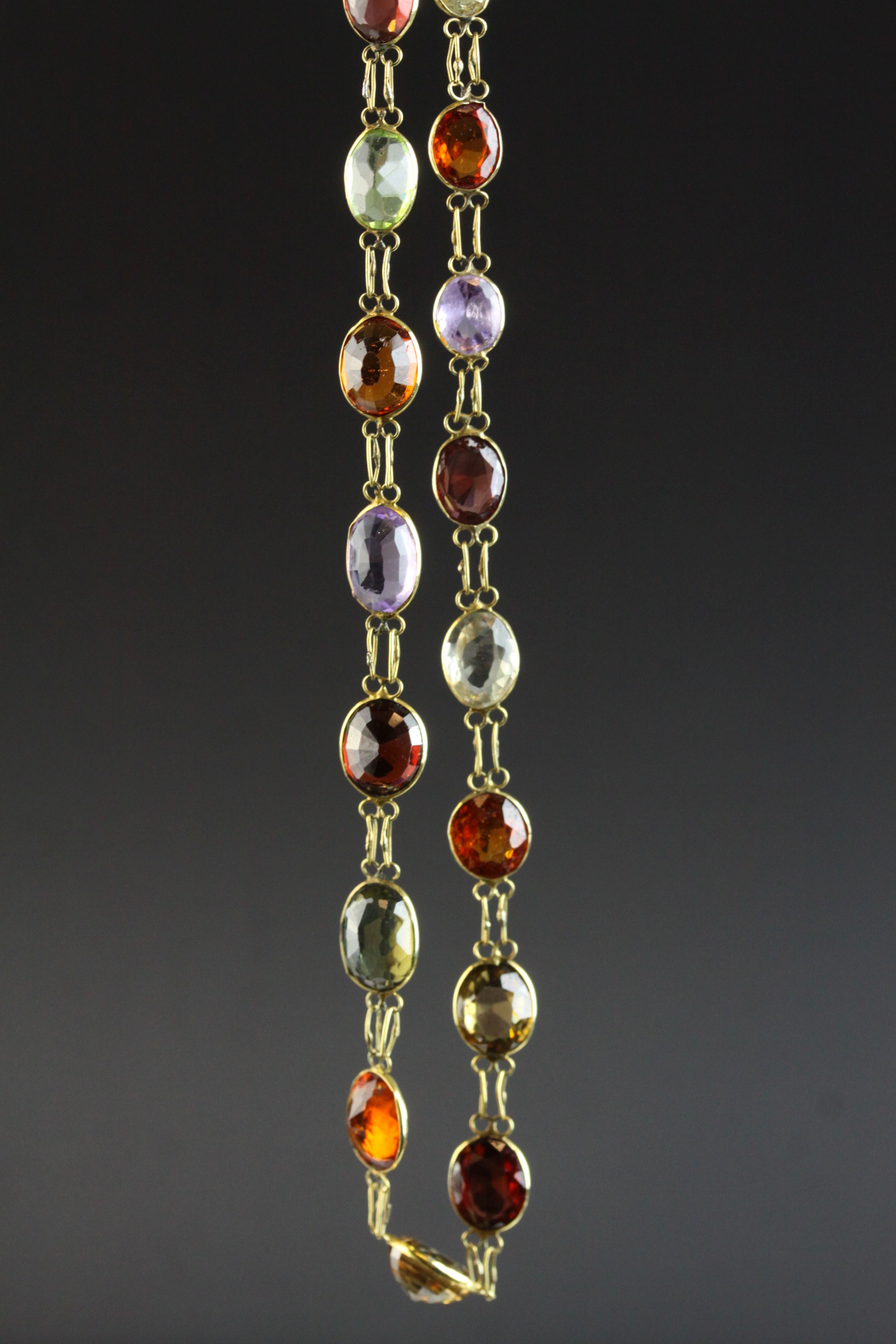 Multi gemstone unmarked yellow gold riviere necklace, comprising garnet, orange garnet, citrine,