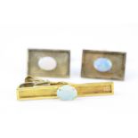 Pair of opal 18ct yellow gold cufflinks, the textured rectangular panel set with oval cabochon cut