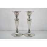 Pair of silver candlesticks, tapered hexagonal stem and hexagonal weighted base, makers Deakin &